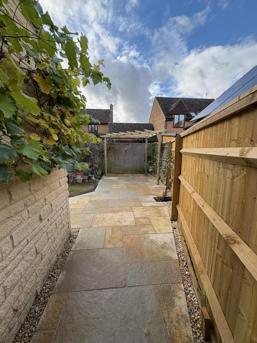 After: a new sandstone path running between the stone wall and the fence