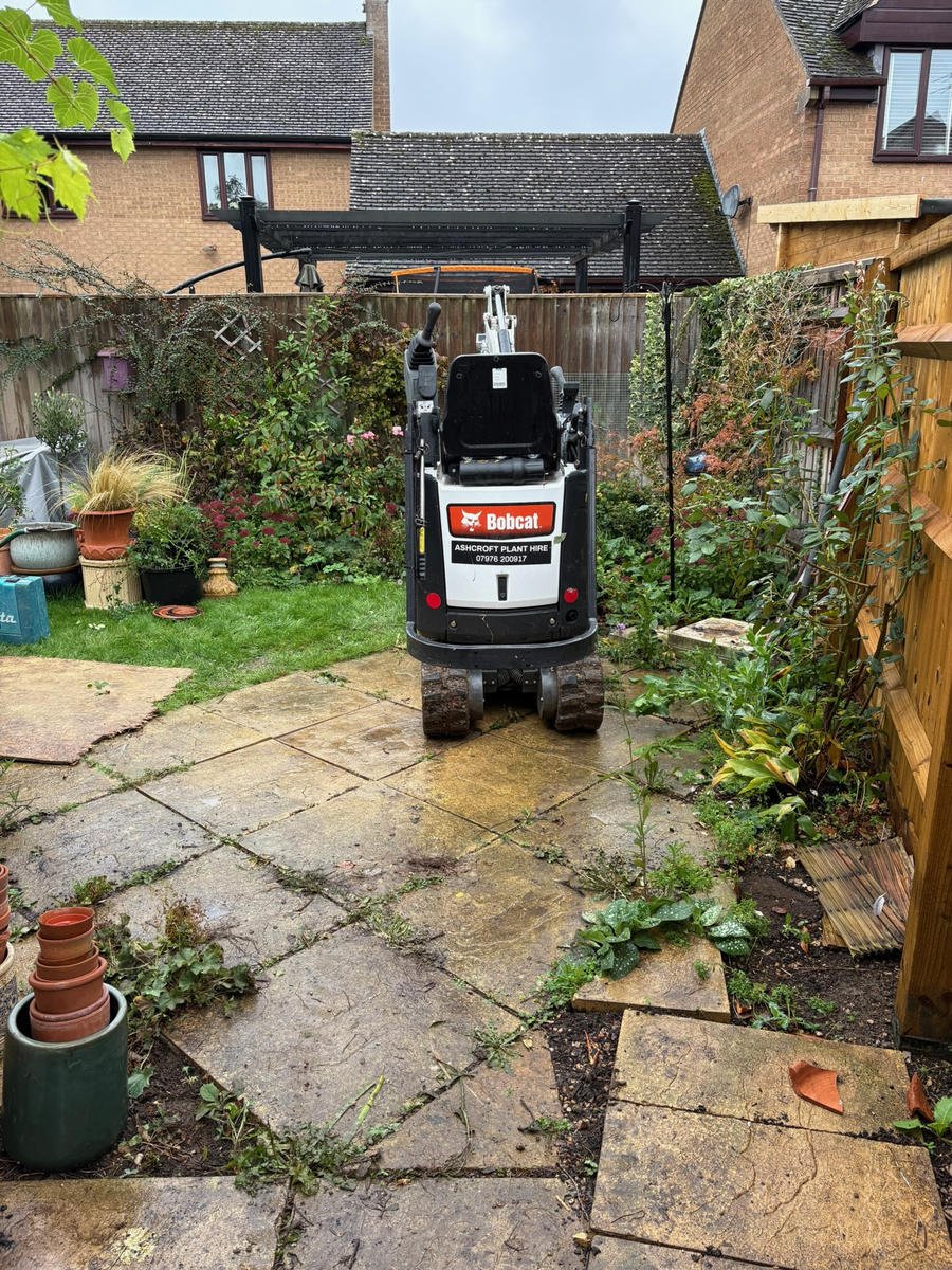 Before: a cracked, uneven side path with a mini digger standing on it