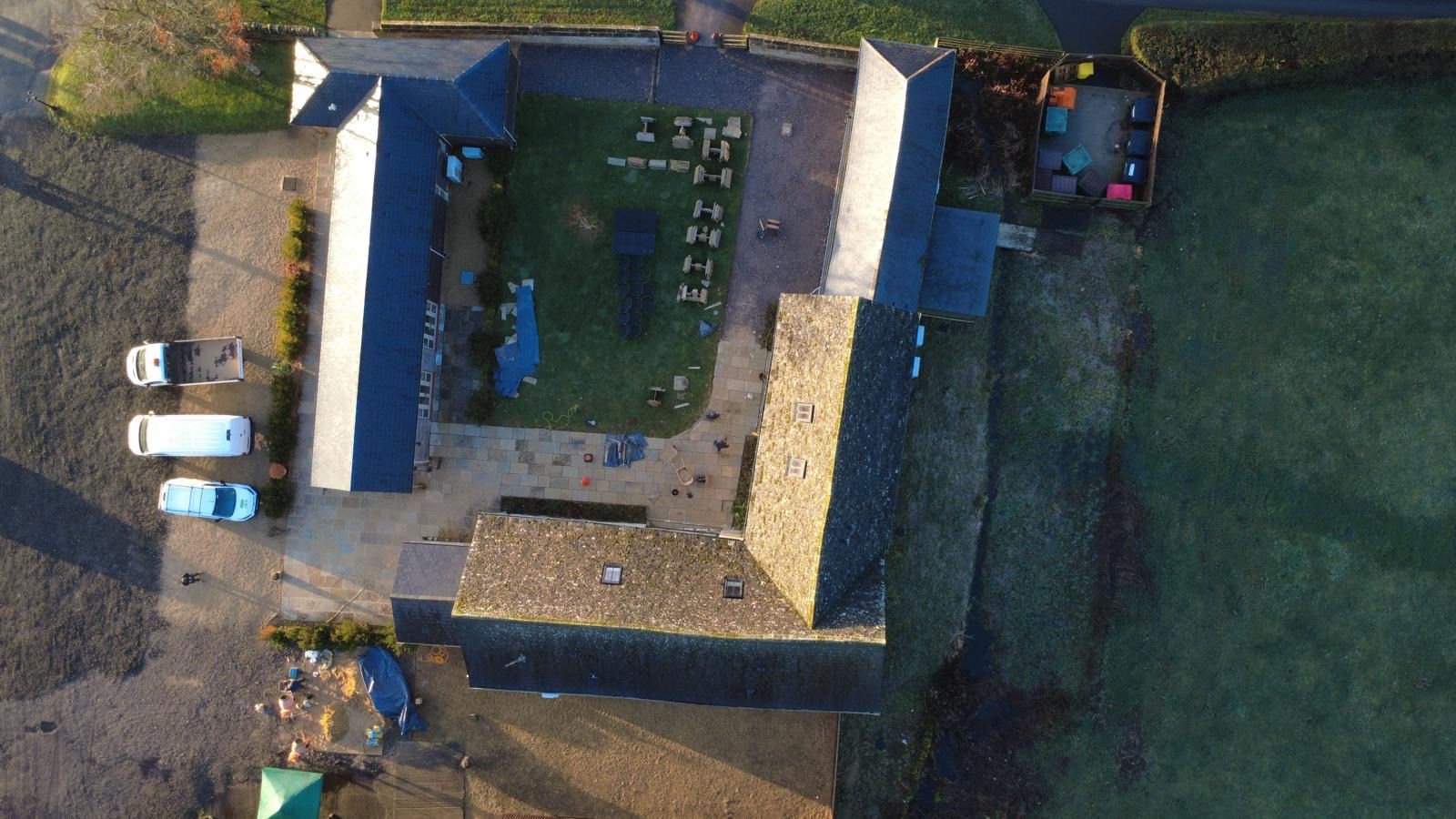 Caswell House from above: the new limestone courtyard laid between the converted farmhouse buildings