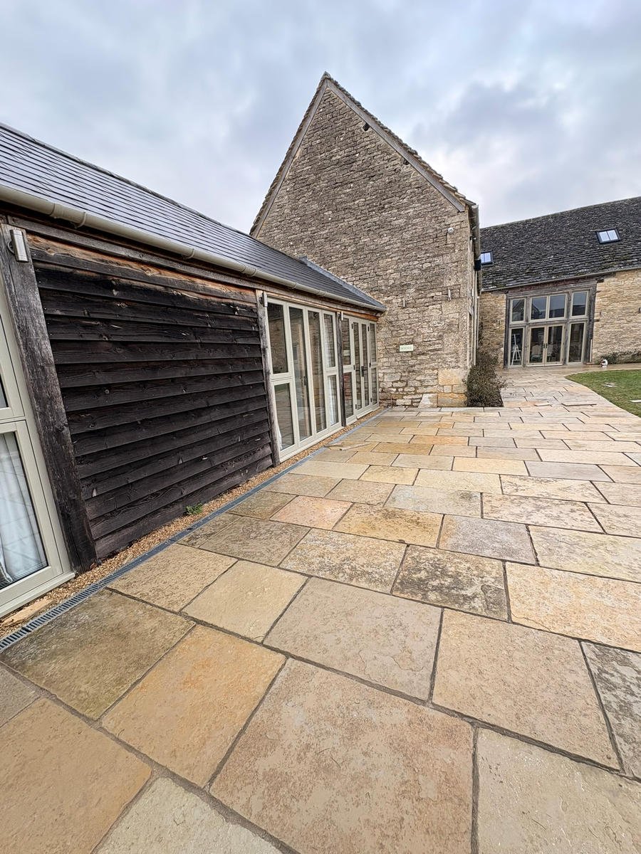 After: the finished limestone courtyard running between the barn and the house