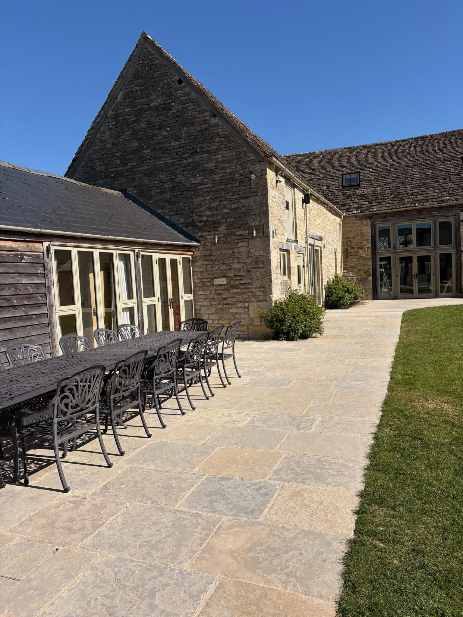 The finished courtyard set with a long dining table for guests