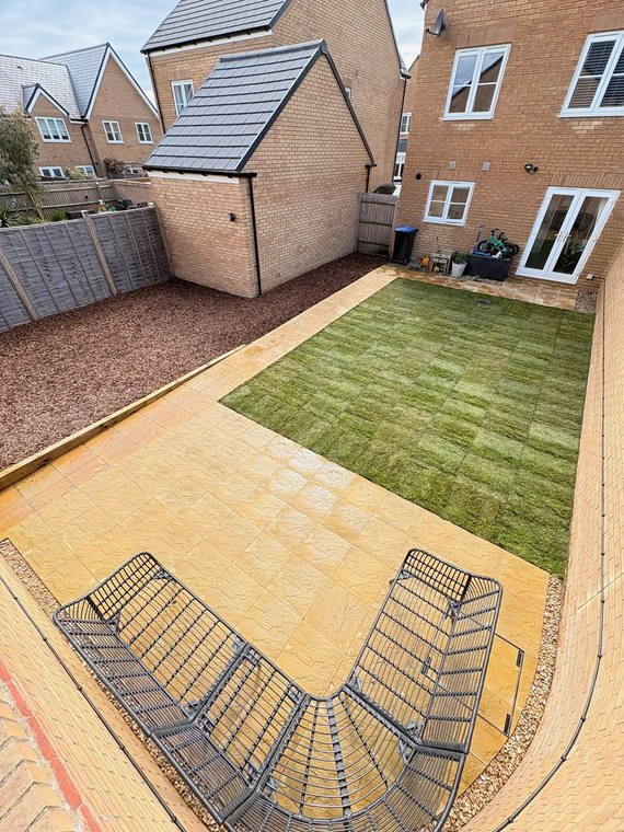 Block paving and freshly laid turf behind a new-build house