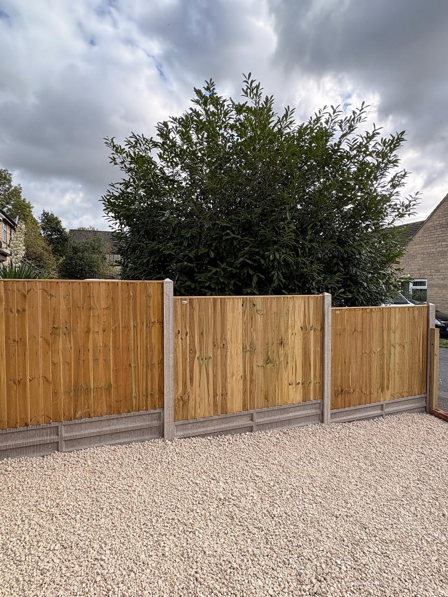 New close-board fencing and a gate on a gravel drive