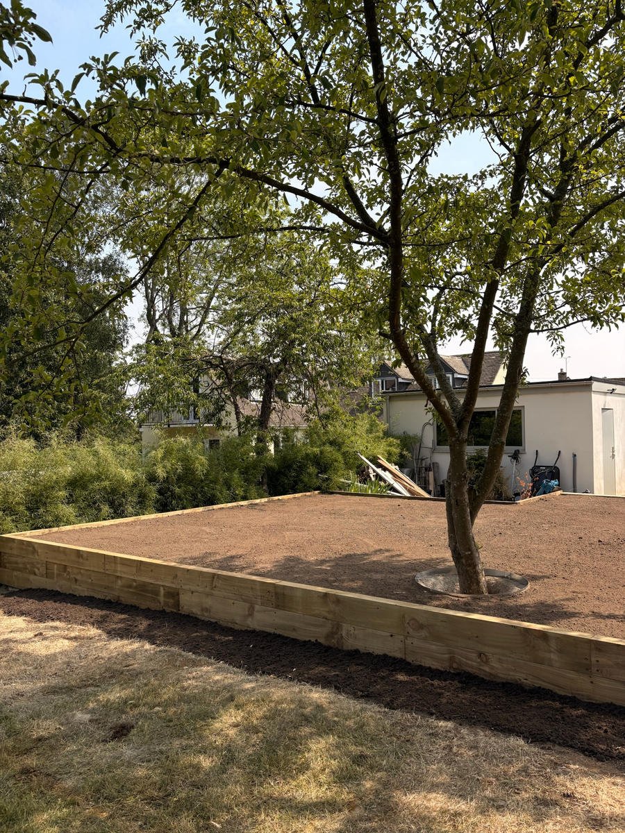 The finished sleeper-faced retaining wall holding the raised soil bed