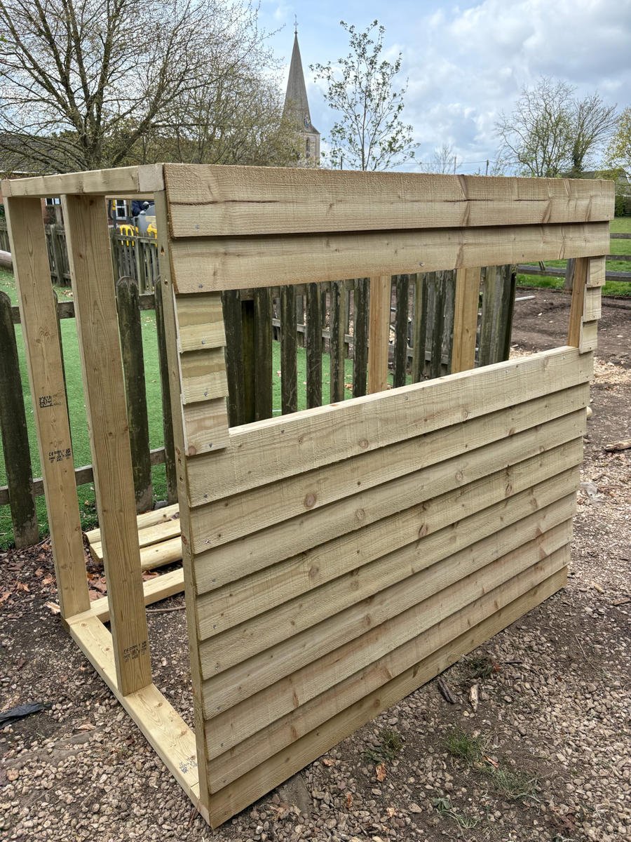 The bird hide part-built, showing the slatted timber frame
