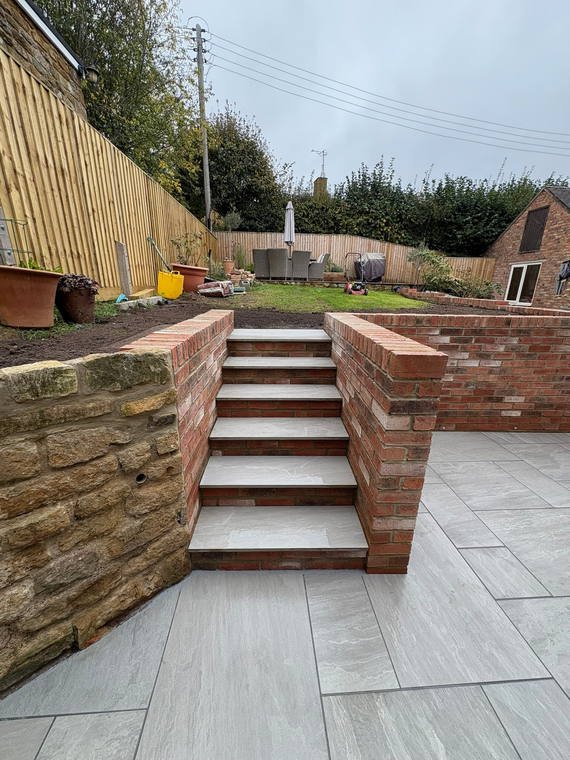 Porcelain-tread steps rising between two brick retaining walls
