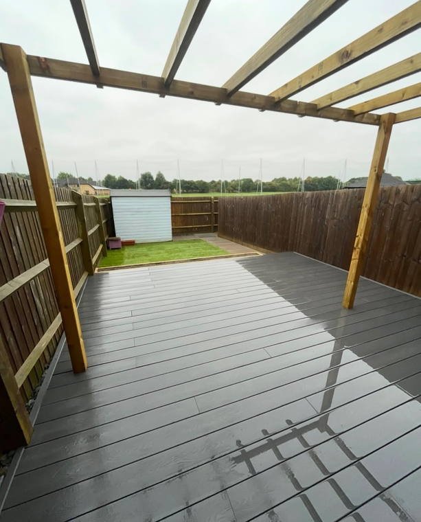 A composite deck under a timber pergola, looking out over open fields