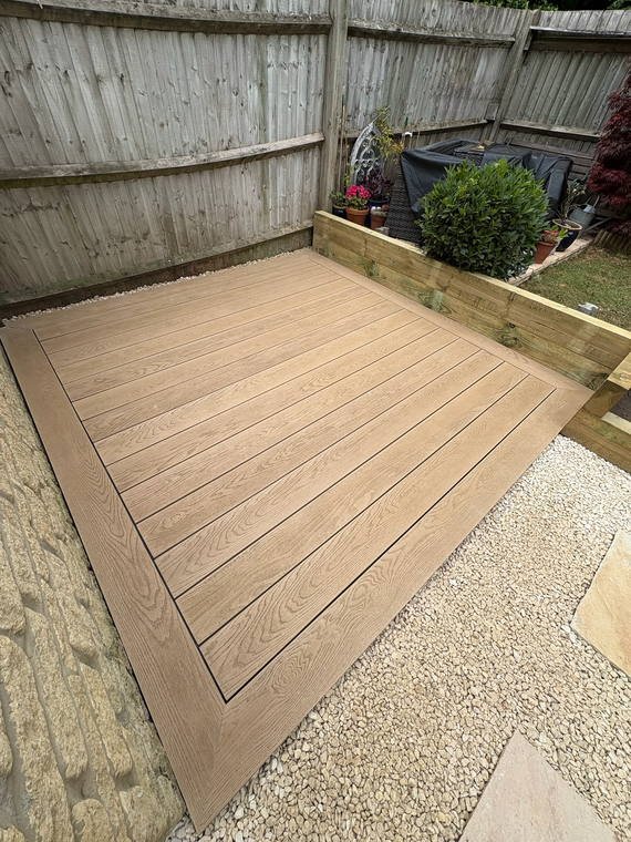 A composite deck meeting sandstone stepping stones set through gravel